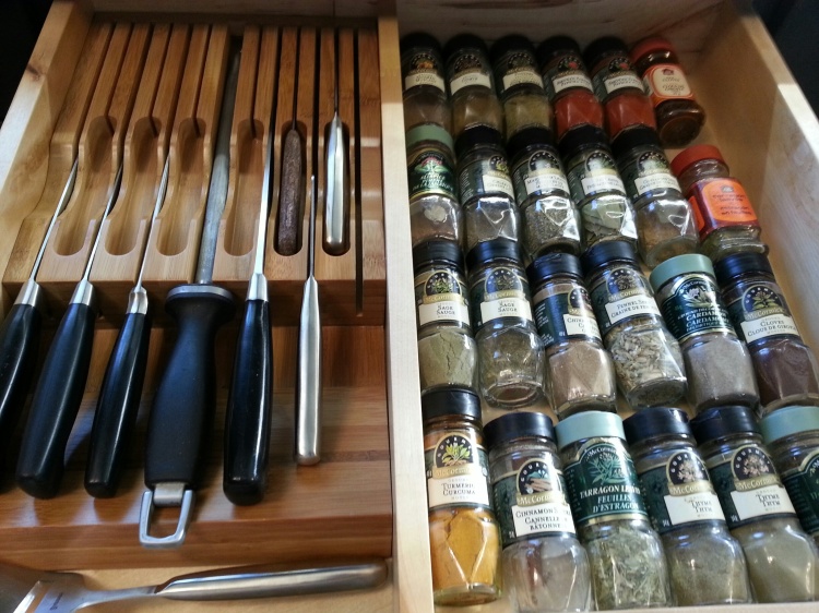 After discovering the forgotten food bins, and dozens more spice bottles, we had to rethink our spice storage.  I had managed to get all the bottles of oils, vinegars, and spices into our pullout next to the stove, but the additional spices demanded a rethink.  We decided to put the smaller bottles into one side of the knife drawer, directly across from the stove.  It meant a purge of unused and duplicate spices, but it was worth it.  